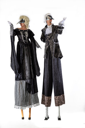 Stilt walkers in venetian costumes and masks